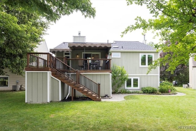 89 Rambling Rd, Amherst, NY 14051 - rear view of house featuring stairway, a chimney, and a lawn
