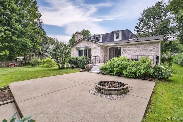 210 Townline Rd, Elma, NY 14059 - view of front of house with an outdoor fire pit, brick siding, a patio, and a front lawn