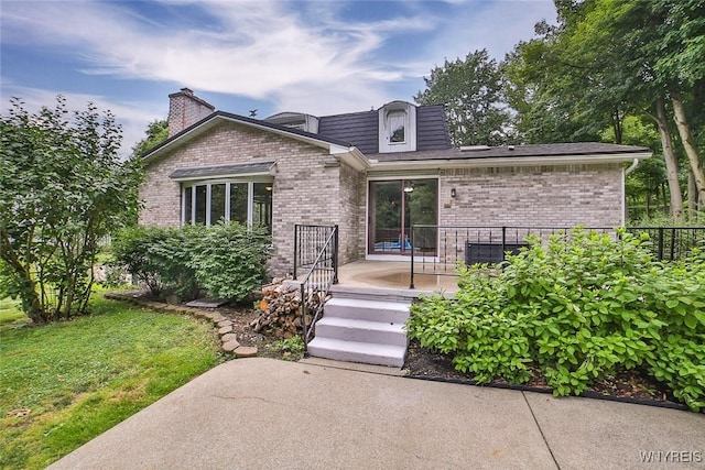 210 Townline Rd, Elma, NY 14059 - view of front of property with brick siding, a chimney, and a patio