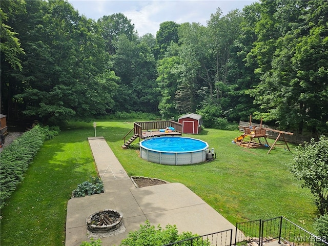 210 Townline Rd, Elma, NY 14059 - view of grassy yard with an outdoor pool, a shed, a playground, and a view of trees