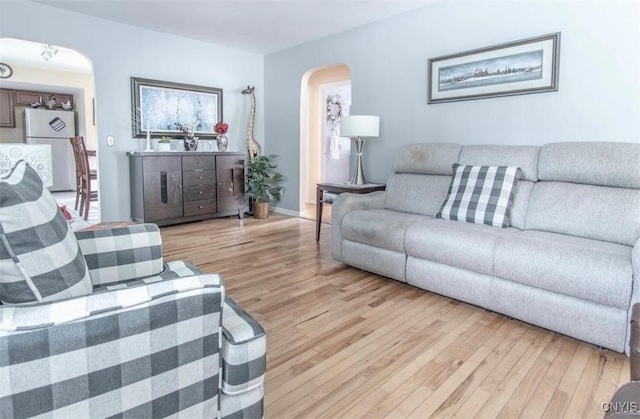 156 Barben Ave, Watertown City, NY 13601 - living area featuring arched walkways and light wood finished floors