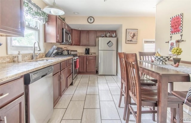 156 Barben Ave, Watertown City, NY 13601 - kitchen featuring stainless steel appliances, healthy amount of natural light, light stone countertops, and light tile patterned flooring