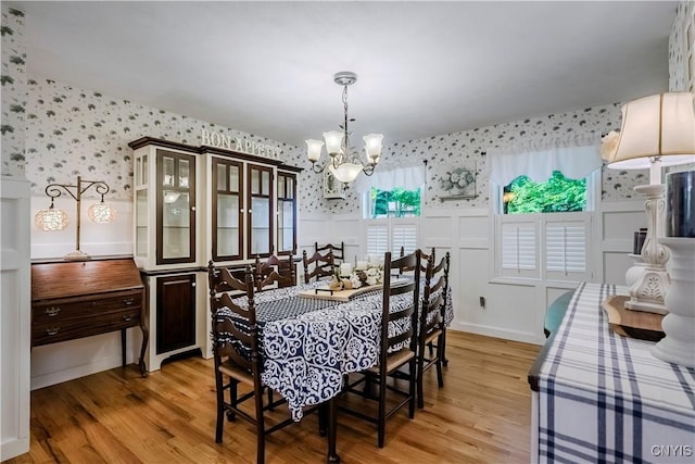 5 Family Cir, Lee, NY 13363 - dining space with wallpapered walls, a chandelier, light wood-style floors, and a wainscoted wall