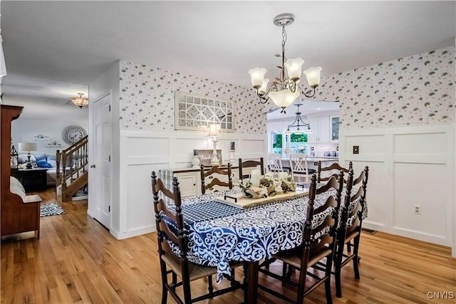 5 Family Cir, Lee, NY 13363 - dining room with wallpapered walls, a decorative wall, a chandelier, wainscoting, and light wood-style flooring