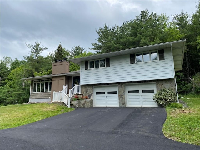 2115 Hornby Rd, Orange, NY 14812 - tri-level home with asphalt driveway, a chimney, a garage, and a front yard