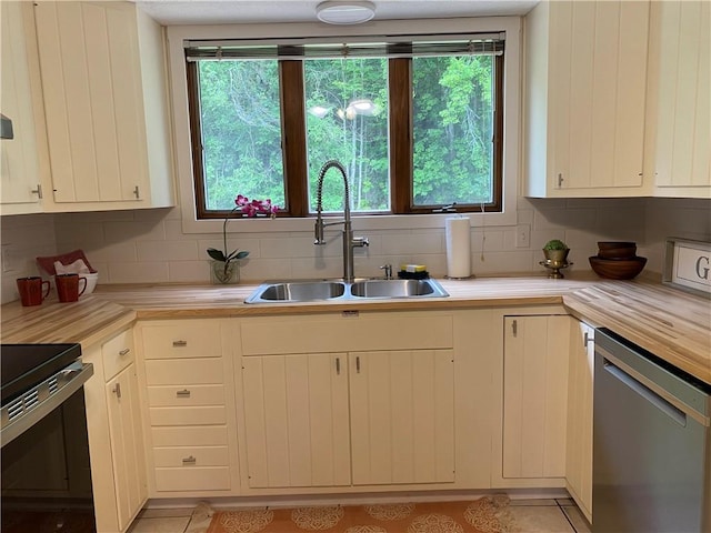2115 Hornby Rd, Orange, NY 14812 - kitchen featuring stainless steel dishwasher, stove, light countertops, backsplash, and light tile patterned floors