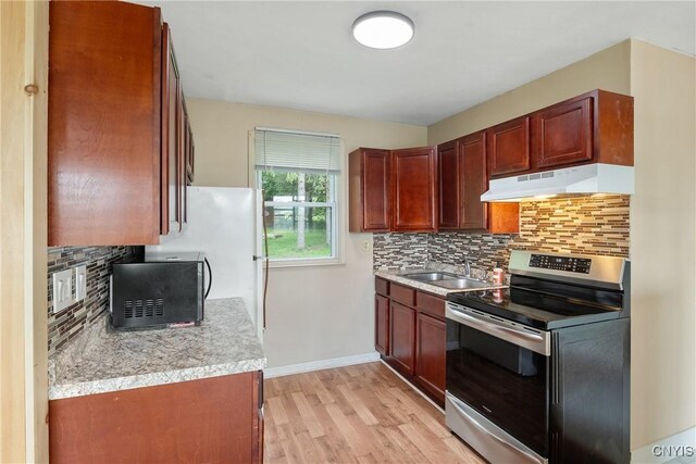 2129 Berry Rd, Lafayette, NY 13084 - kitchen featuring stainless steel range with electric cooktop, under cabinet range hood, black microwave, backsplash, and light countertops