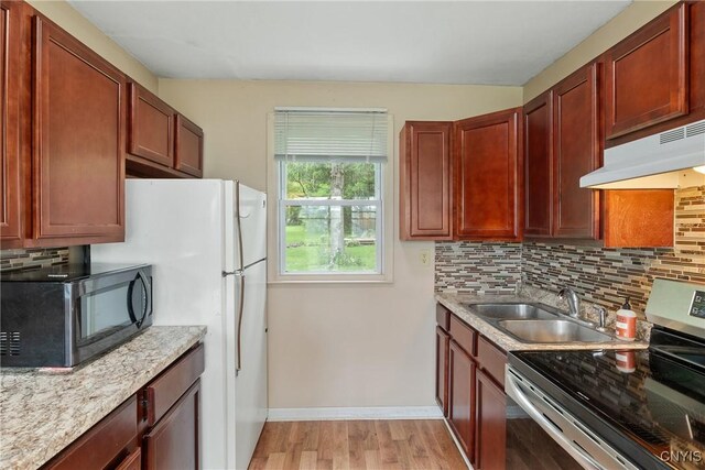 2129 Berry Rd, Lafayette, NY 13084 - kitchen featuring electric stove, black microwave, under cabinet range hood, tasteful backsplash, and light wood finished floors