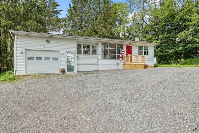 2129 Berry Rd, Lafayette, NY 13084 - view of front of property featuring driveway, a garage, and view of scattered trees