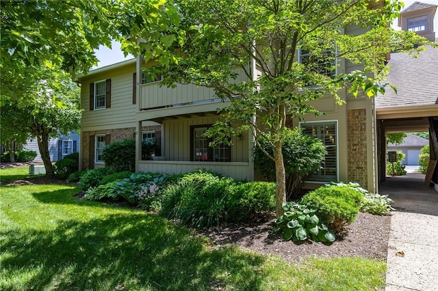 42 Wood Creek Dr, Pittsford, NY 14534 - view of front of house with brick siding, a front yard, and board and batten siding
