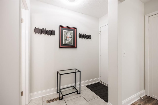 42 Wood Creek Dr, Pittsford, NY 14534 - hallway featuring baseboards and tile patterned floors