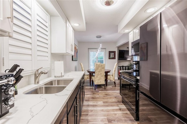 42 Wood Creek Dr, Pittsford, NY 14534 - kitchen featuring stainless steel appliances, white cabinetry, pendant lighting, light wood-type flooring, and light stone countertops