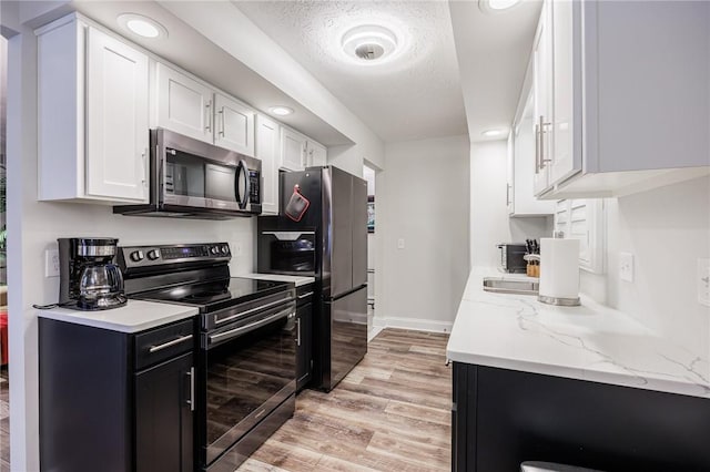 42 Wood Creek Dr, Pittsford, NY 14534 - kitchen featuring appliances with stainless steel finishes, light wood-style floors, and white cabinets