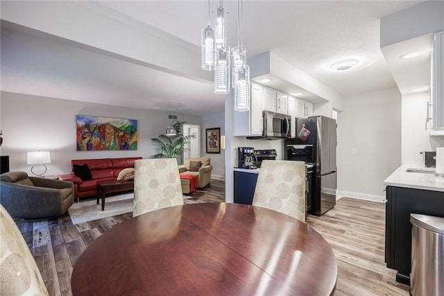 42 Wood Creek Dr, Pittsford, NY 14534 - dining area with light wood-style flooring and baseboards