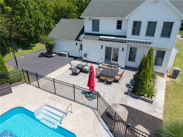 255 Watson Rd, Perinton, NY 14450 - back of property with a patio, outdoor dining area, a shingled roof, and an outdoor fire pit