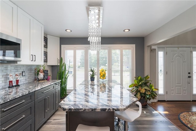 255 Watson Rd, Perinton, NY 14450 - dining area with plenty of natural light, wood finished floors, recessed lighting, and a chandelier