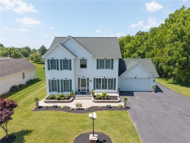 255 Watson Rd, Perinton, NY 14450 - colonial-style house featuring asphalt driveway, an attached garage, a front lawn, and roof with shingles