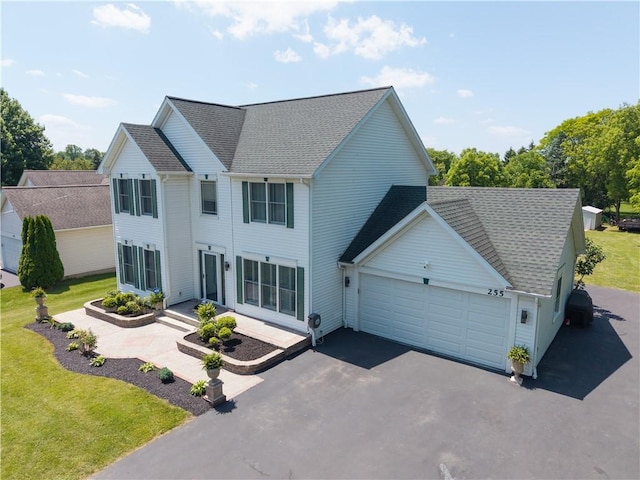 255 Watson Rd, Perinton, NY 14450 - view of front of house featuring an attached garage, driveway, a shingled roof, and a front yard