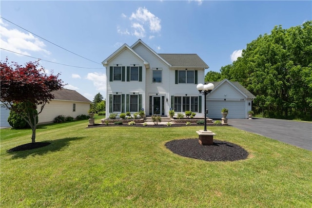 255 Watson Rd, Perinton, NY 14450 - view of front of house featuring driveway, an attached garage, and a front lawn