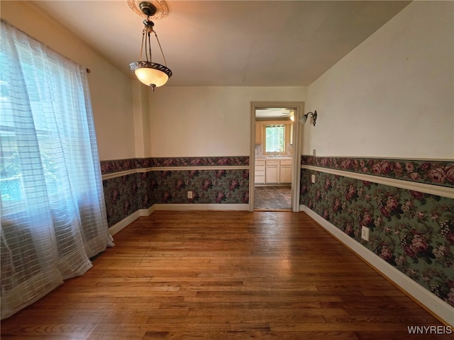 942 N 4th St, Olean, NY 14760 - spare room featuring wallpapered walls, a wainscoted wall, and wood finished floors