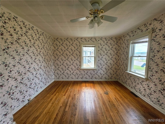942 N 4th St, Olean, NY 14760 - empty room featuring hardwood / wood-style floors, wallpapered walls, and ceiling fan
