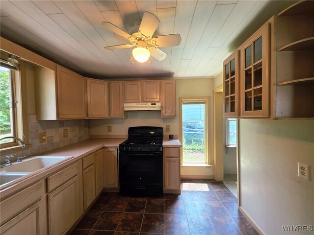 942 N 4th St, Olean, NY 14760 - kitchen with black gas range, under cabinet range hood, healthy amount of natural light, and light countertops