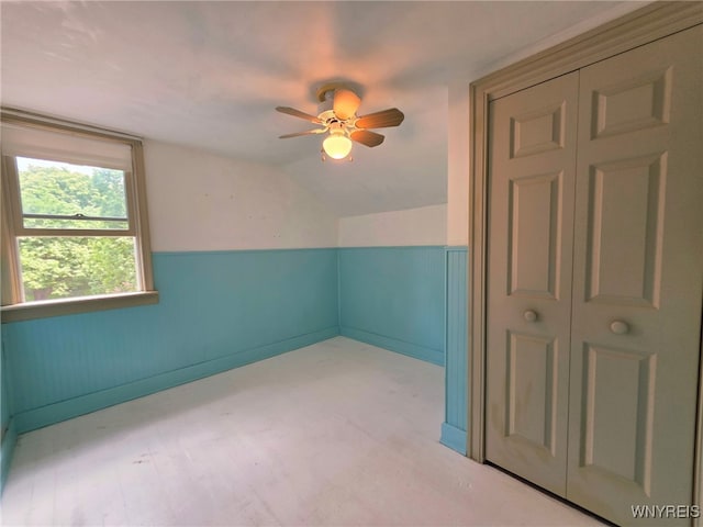 942 N 4th St, Olean, NY 14760 - empty room with a ceiling fan, a wainscoted wall, and vaulted ceiling