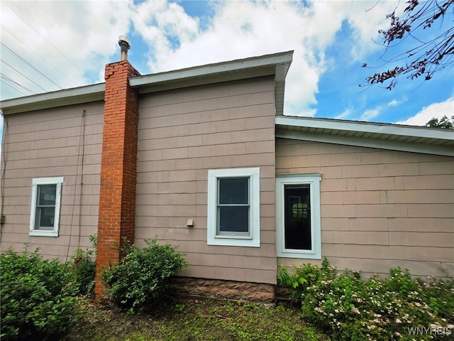 942 N 4th St, Olean, NY 14760 - view of side of home featuring a chimney