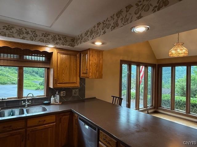 2033 Artemis Dr, Virgil, NY 13045 - kitchen with dishwasher, brown cabinets, recessed lighting, hanging light fixtures, and backsplash