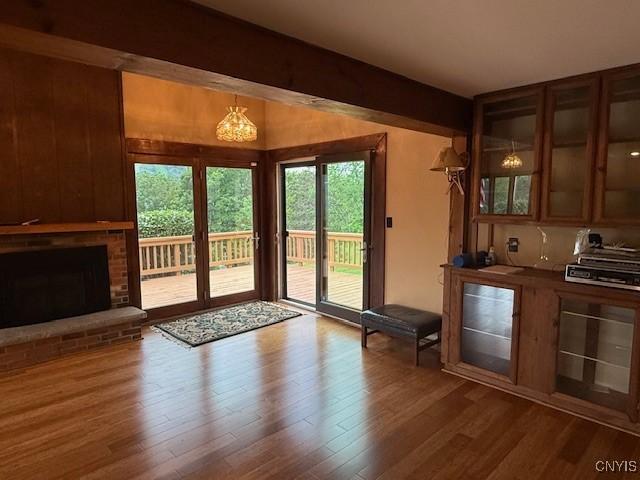 2033 Artemis Dr, Virgil, NY 13045 - doorway to outside with healthy amount of natural light, wood finished floors, and a fireplace