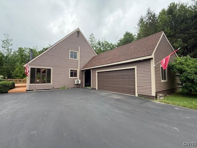 2033 Artemis Dr, Virgil, NY 13045 - view of front of house featuring an attached garage and asphalt driveway
