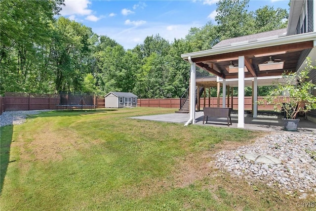 9545 Horseshoe Island Rd, Clay, NY 13041 - fenced backyard with a storage unit, a patio area, stairs, a trampoline, and a ceiling fan
