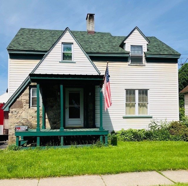 81 Silver St, Norwich, NY 13815 - view of front of home with covered porch, a chimney, a front yard, roof with shingles, and stone siding