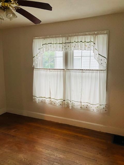 81 Silver St, Norwich, NY 13815 - unfurnished room with dark wood-style floors and a ceiling fan