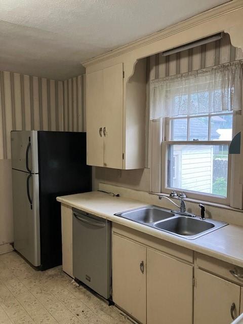 81 Silver St, Norwich, NY 13815 - kitchen with dishwasher, light countertops, freestanding refrigerator, wallpapered walls, and a textured ceiling