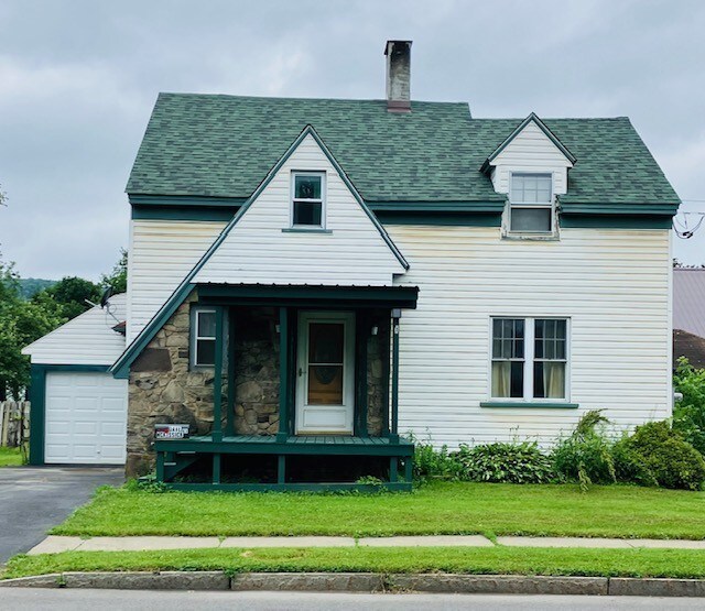 81 Silver St, Norwich, NY 13815 - view of front of house featuring a garage, a front yard, roof with shingles, a chimney, and stone siding