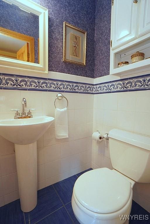 57 Dudley Ave, Hamburg, NY 14075 - bathroom featuring tile walls, a wainscoted wall, and tile patterned flooring