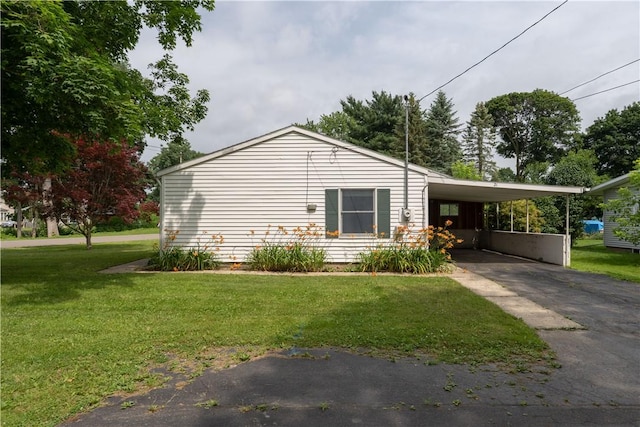 21 Twin Dr, North Dansville, NY 14437 - view of side of property featuring driveway, an attached carport, and a lawn