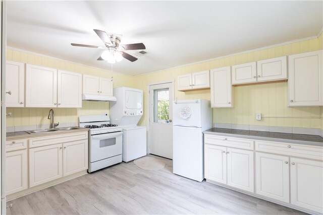 21 Twin Dr, North Dansville, NY 14437 - kitchen featuring white appliances, under cabinet range hood, stacked washer / dryer, a ceiling fan, and light wood-style floors