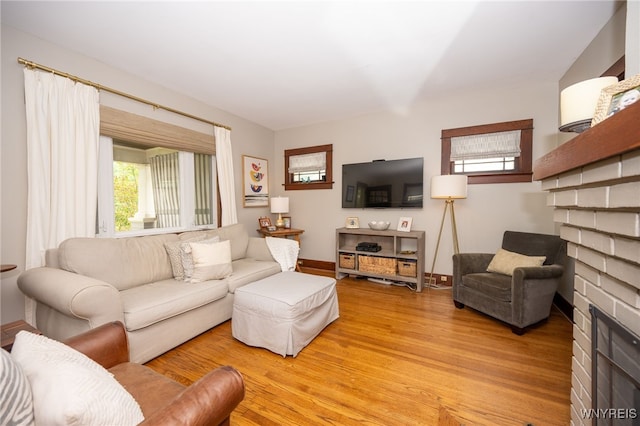 128 Argonne Dr, Tonawanda, NY 14217 - living room with a fireplace, healthy amount of natural light, and light wood-style flooring