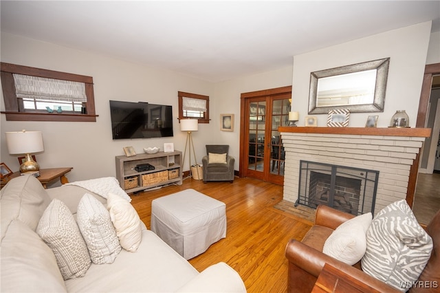 128 Argonne Dr, Tonawanda, NY 14217 - living room with wood finished floors and a brick fireplace