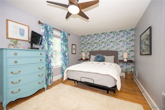 128 Argonne Dr, Tonawanda, NY 14217 - bedroom featuring a ceiling fan, wood finished floors, and wallpapered walls