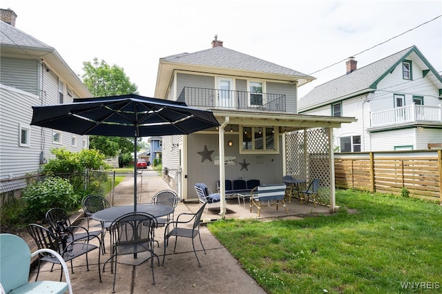 128 Argonne Dr, Tonawanda, NY 14217 - rear view of house featuring a patio area, a fenced backyard, outdoor dining area, and a chimney