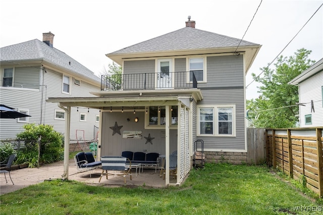 128 Argonne Dr, Tonawanda, NY 14217 - rear view of property featuring a balcony, a patio, a fenced backyard, an outdoor hangout area, and a chimney