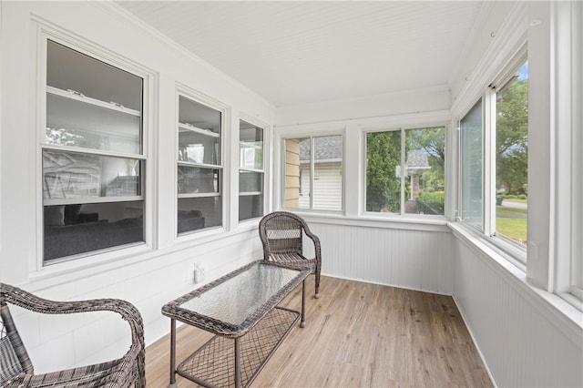 111 Hartsdale Rd, Irondequoit, NY 14622 - sunroom / solarium featuring wood finished floors, plenty of natural light, crown molding, and a wainscoted wall
