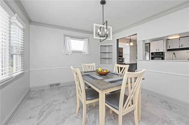 111 Hartsdale Rd, Irondequoit, NY 14622 - dining space featuring a chandelier, ornamental molding, and light marble finish flooring