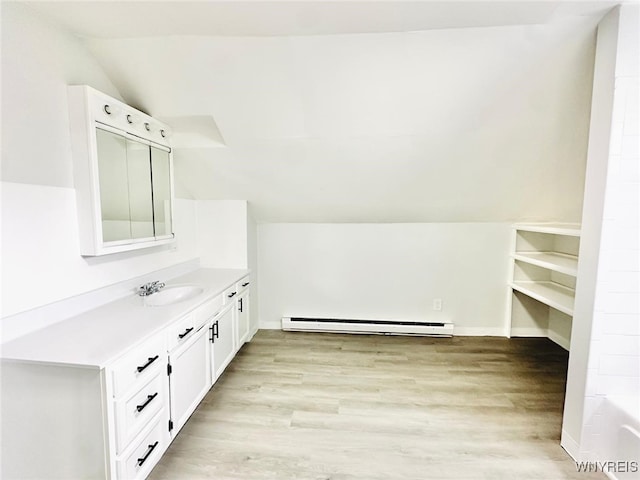 169 Davidson Ave, Buffalo, NY 14215 - full bathroom with baseboard heating, vaulted ceiling, vanity, wood finished floors, and a bathtub