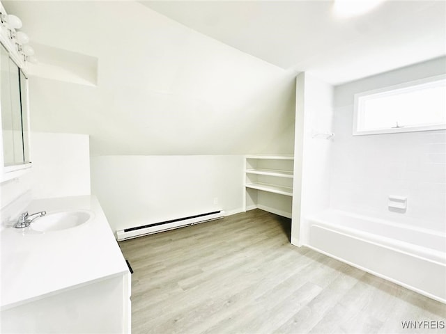169 Davidson Ave, Buffalo, NY 14215 - bathroom with a baseboard heating unit, vanity, wood finished floors, and  shower combination