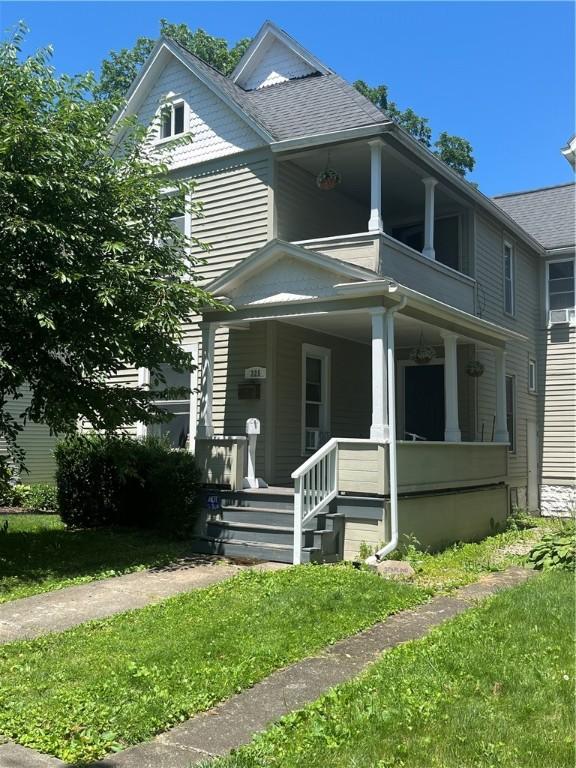 325 E 3rd St, Corning City, NY 14830 - view of front of house with a porch, a shingled roof, and a front lawn