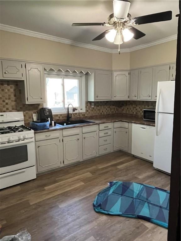 325 E 3rd St, Corning City, NY 14830 - kitchen with white appliances, ornamental molding, dark countertops, backsplash, and dark wood-style flooring